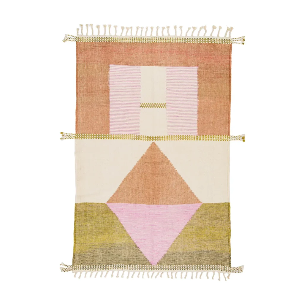 A handwoven rug featuring geometric patterns in pink, orange, beige, and yellow. The design includes stripes, rectangles, and triangles with tassels adorning the short ends.