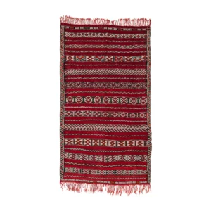 A vintage rectangular red and white patterned flat rug with fringed edges, featuring geometric designs and horizontal stripes.