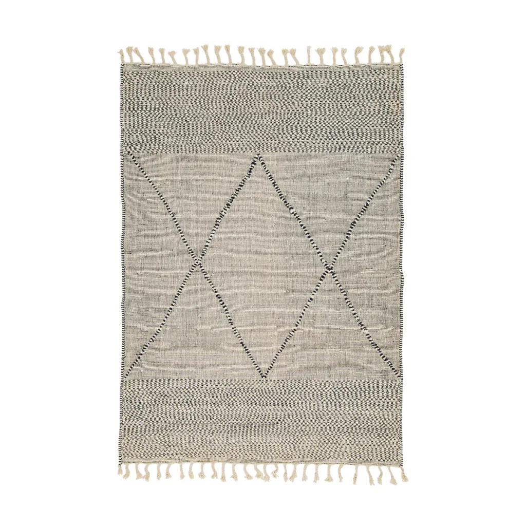 Handwoven rug featuring geometric patterns with triangle and diamond designs. Crafted in neutral tones with fringed edges and intricate weaving for a stylish touch to any room.