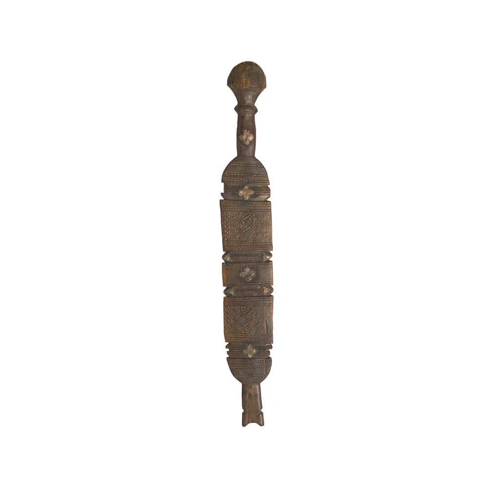 This hand-carved paddle, reminiscent of a vintage wooden tent peg, boasts intricate carvings and three square sections adorned with geometric patterns.