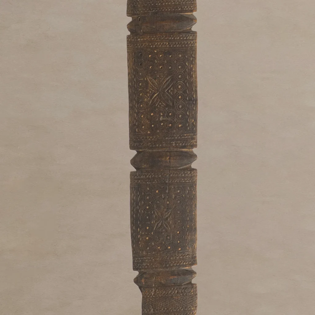 A hand-carved vintage wooden staff with intricate carvings, featuring geometric patterns and dot motifs, reminiscent of an artisans tent peg in its elegance and craftsmanship.