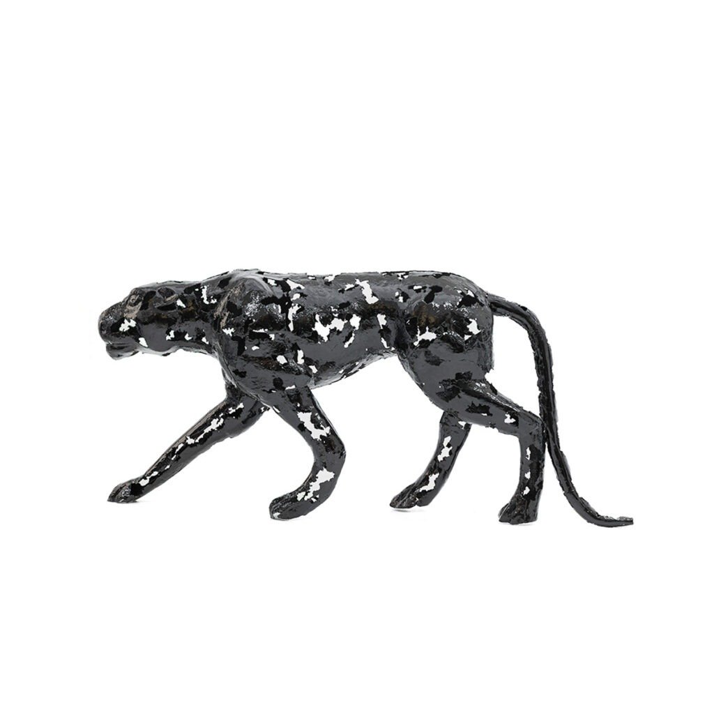 Black and white abstract metalwork sculpture of a walking panther on a white background.