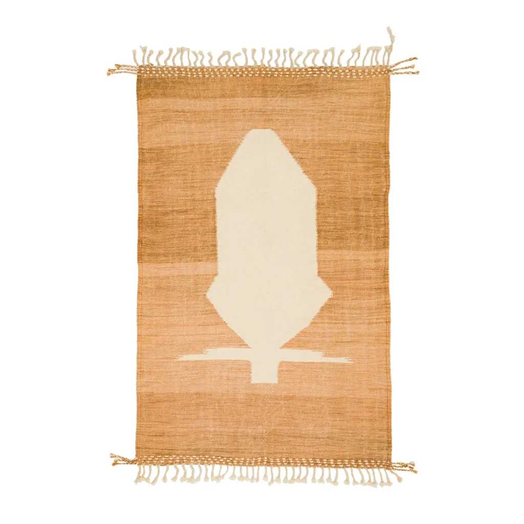 This beige and brown woven rug features a striking geometric pattern at its center, complemented by fringe on the shorter sides. Ideal for adding a touch of elegance to any space, it seamlessly blends style and function.