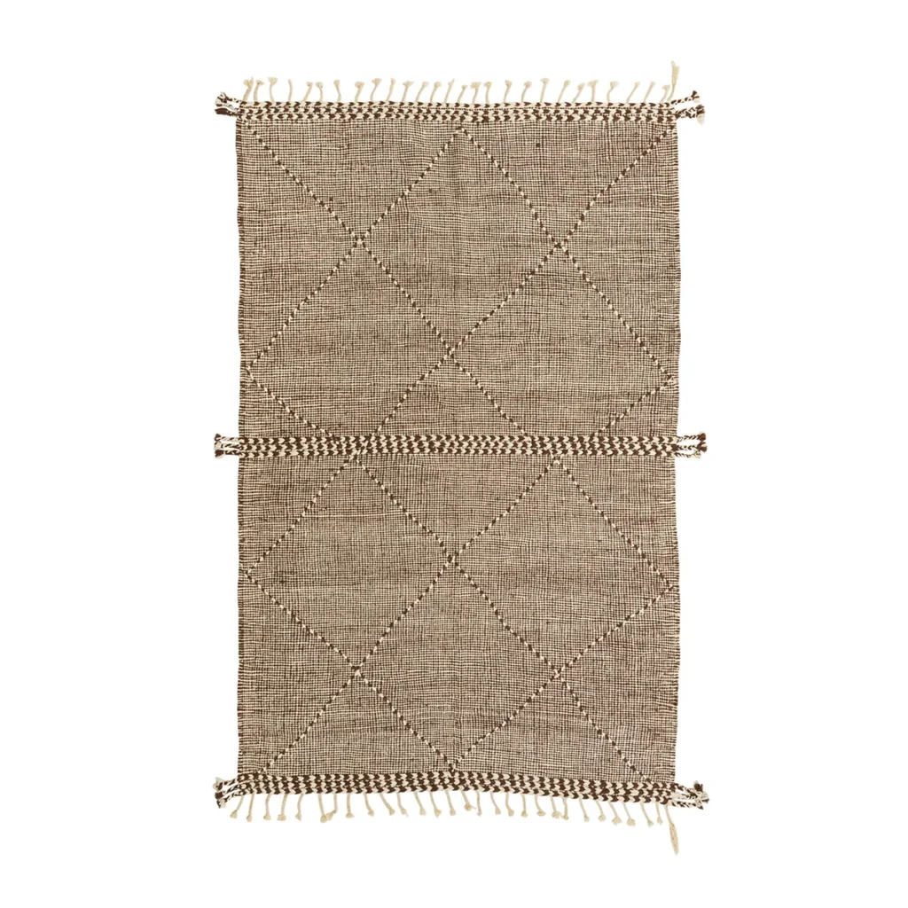 A beige woven rug with a diamond pattern and fringed edges adds subtle elegance to any space.