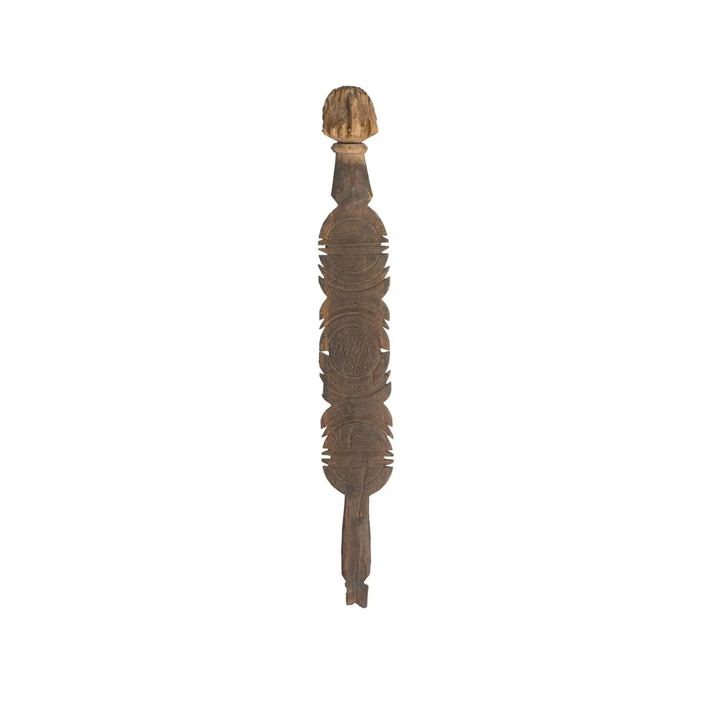 Hand-carved wooden tribal sculpture with an elongated form, featuring intricate carvings and a stylized, rounded head reminiscent of vintage craftmanship.