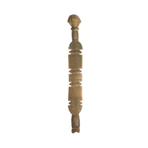 Hand-carved wooden ceremonial staff with intricate carvings and geometric patterns, reminiscent of a vintage tent peg, topped with a human-like figure.