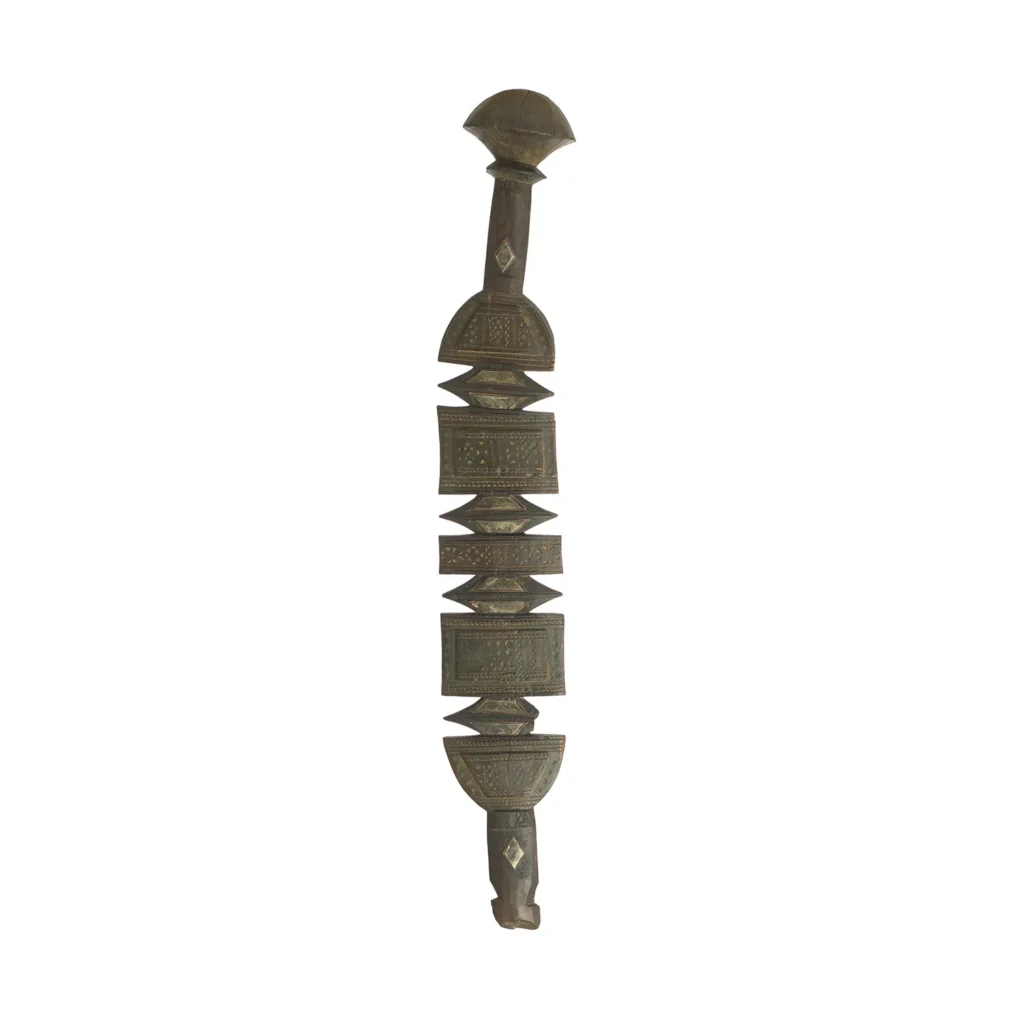 This intricately hand-carved artifact, reminiscent of a vintage wooden tent peg, boasts geometric patterns with stacked shapes and a rounded top.