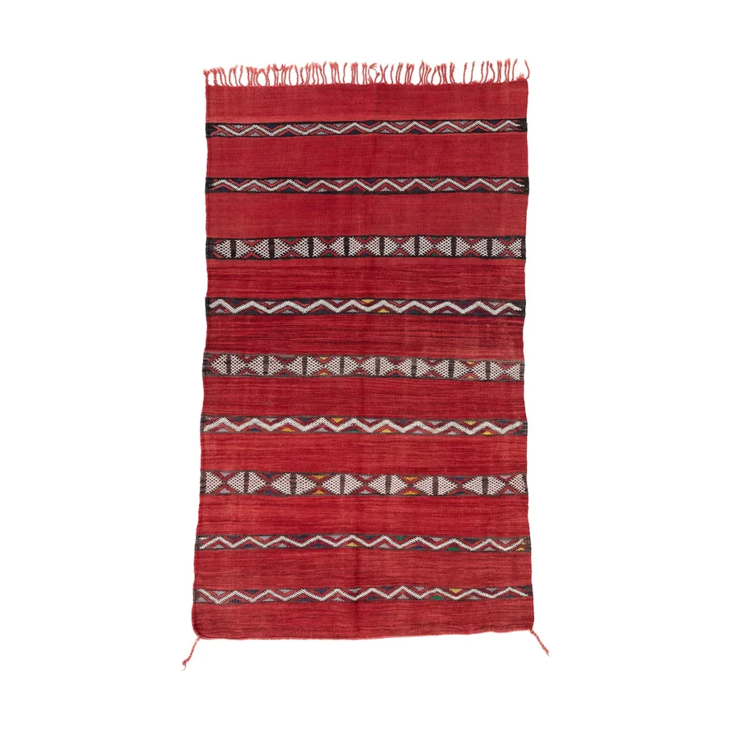 This vintage, handwoven rectangular rug showcases intricate horizontal geometric patterns and fringes along one edge, emphasizing its unique artisan craftsmanship.