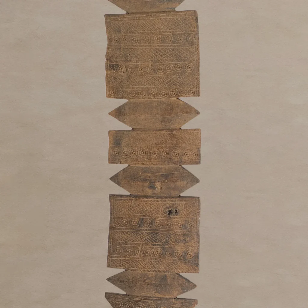 A symmetrical arrangement of flat wooden panels with intricate hand-carved spiral patterns, reminiscent of vintage wooden tent pegs, aligned vertically against a neutral background.