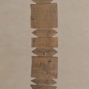 A symmetrical arrangement of flat wooden panels with intricate hand-carved spiral patterns, reminiscent of vintage wooden tent pegs, aligned vertically against a neutral background.