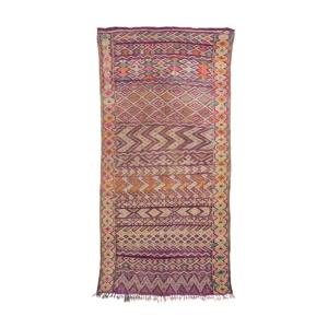 This vintage handwoven rug showcases a multicolored, intricately patterned design with geometric motifs in reds, oranges, purples, and beiges. The rugs artistry is complemented by its fringed ends.
