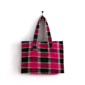 A red, black, and white plaid tote bag hangs on a simple hook against a plain white background.