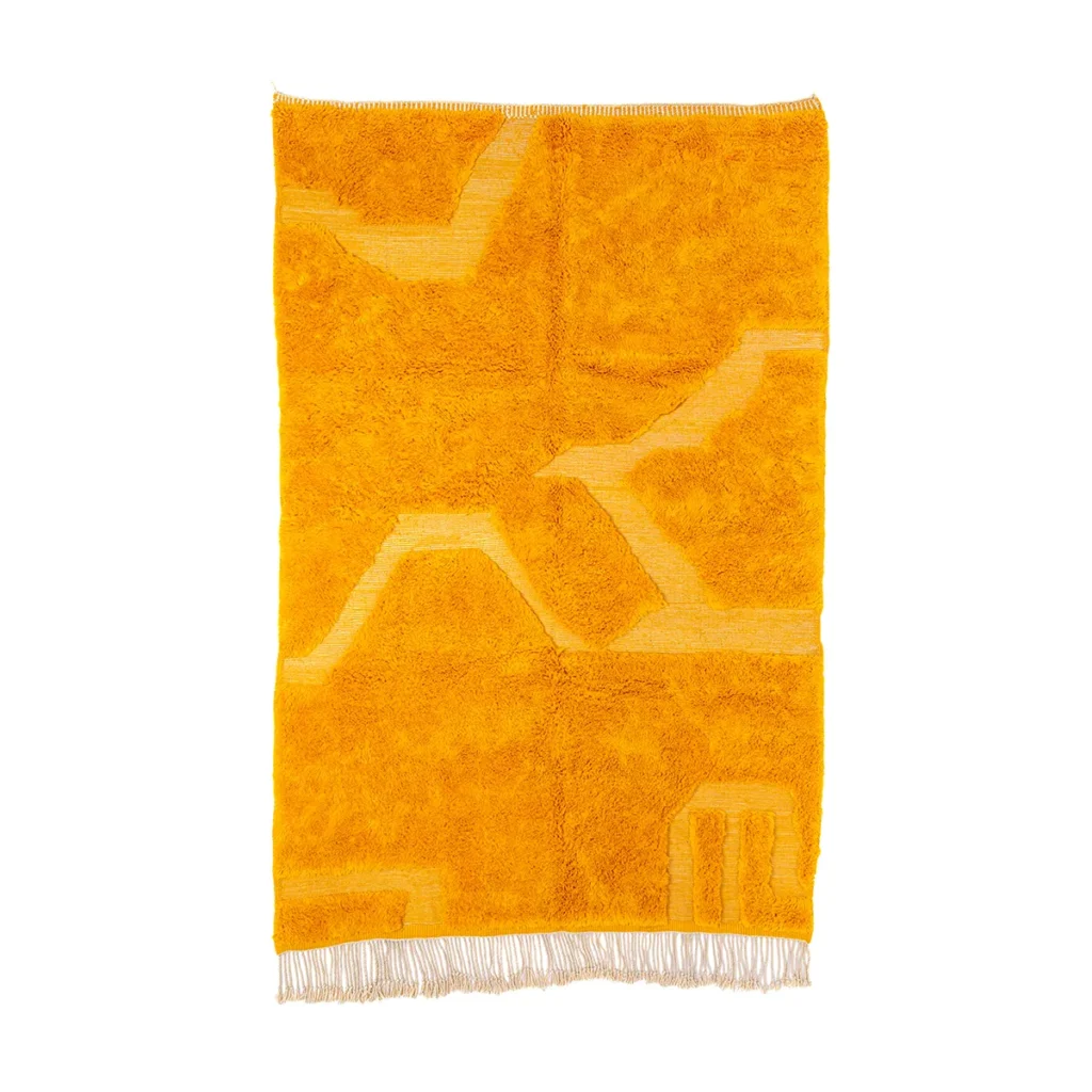 A bright yellow rectangular luxury rug with abstract patterns and fringe at the shorter ends, perfect for adding a touch of elegance to any room.