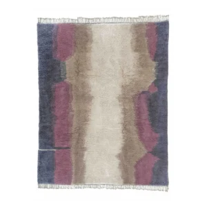 This luxury rug features a rectangular design with an abstract pattern in shades of purple, beige, and blue. The fringed edges enhance its elegant appeal, adding a touch of sophistication to any room.