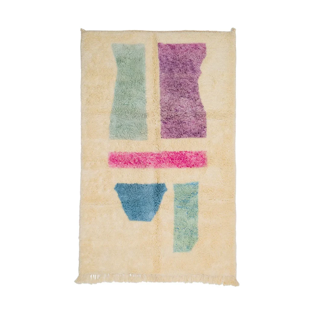 A beige rectangular rug adorned with abstract shapes in green, purple, pink, and blue. It features a textured finish and fringe on the shorter sides, perfect for adding a touch of artistry to any space.