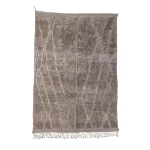 A rectangular, beige hand-knotted rug with a textured, intersecting line pattern and fringe along the bottom edge, set against a white background.