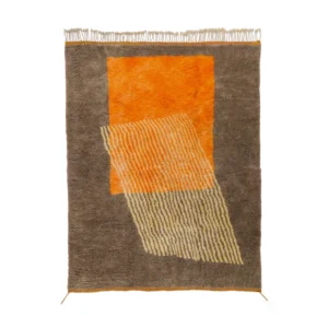 A rectangular area rug with fringes showcases an abstract design featuring a large tangerine rectangle complemented by a diagonal striped pattern against a warm brown background.
