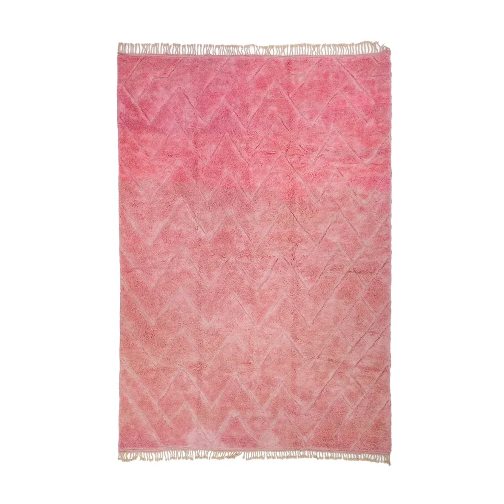 Experience the elegance of this luxury pink rug, featuring a hand-knotted design with a striking zigzag pattern and short fringe on the top and bottom edges.