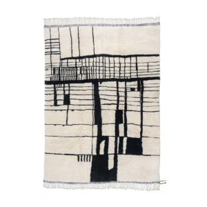 This luxury Moroccan rug showcases an abstract black line pattern on a white background and features fringe edges on two sides.
