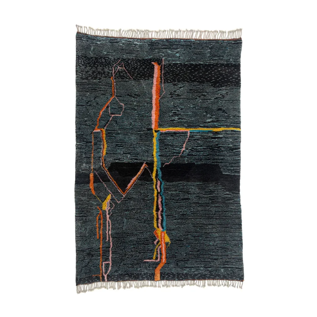 This luxury hand-knotted rug showcases a textured dark surface with multicolored linear patterns and fringed edges, predominantly in black, orange, and yellow.