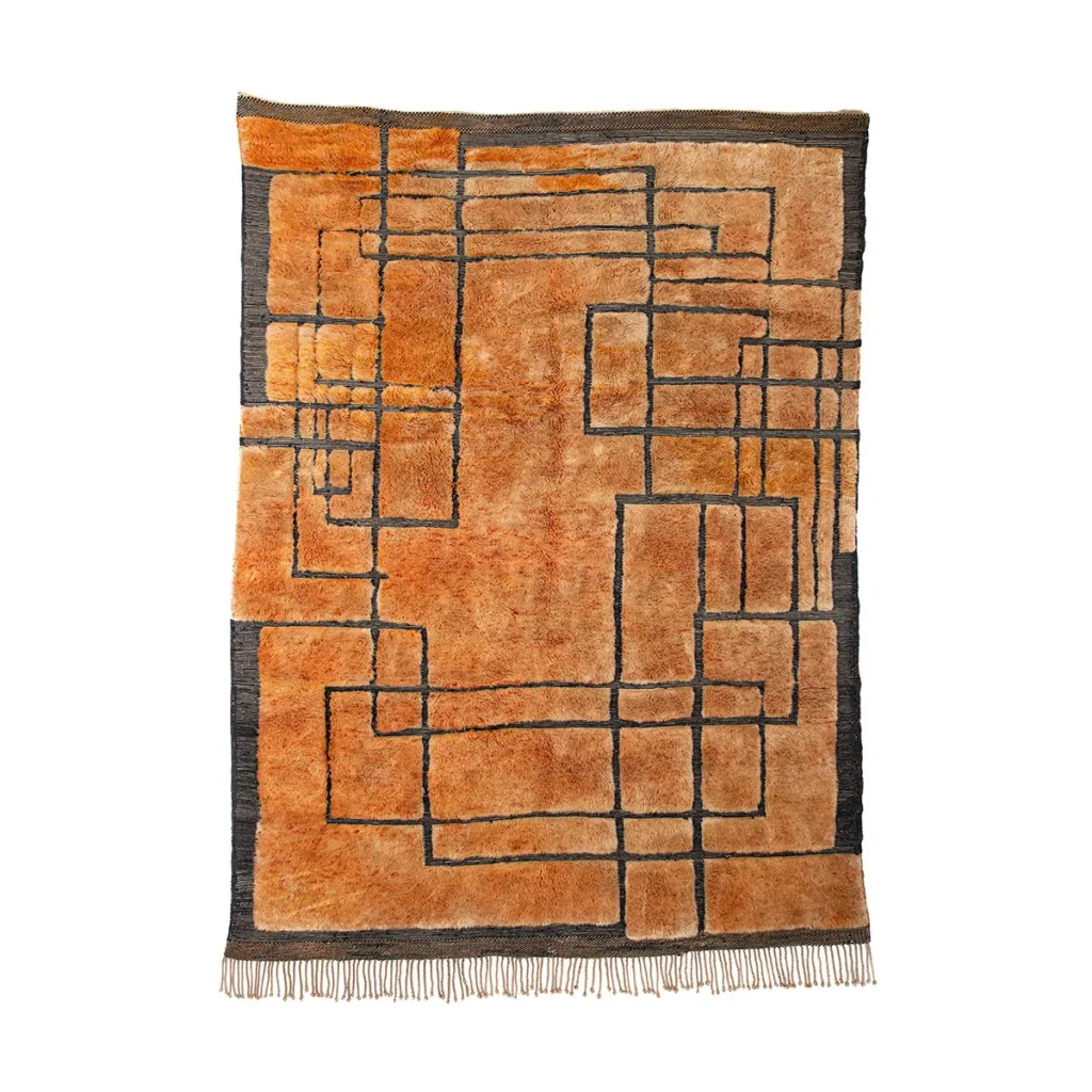 A luxurious rectangular rug showcases an abstract geometric design with intersecting lines in orange and black tones, enhanced by fringe on the bottom edge. This hand-knotted masterpiece adds elegance to any room.