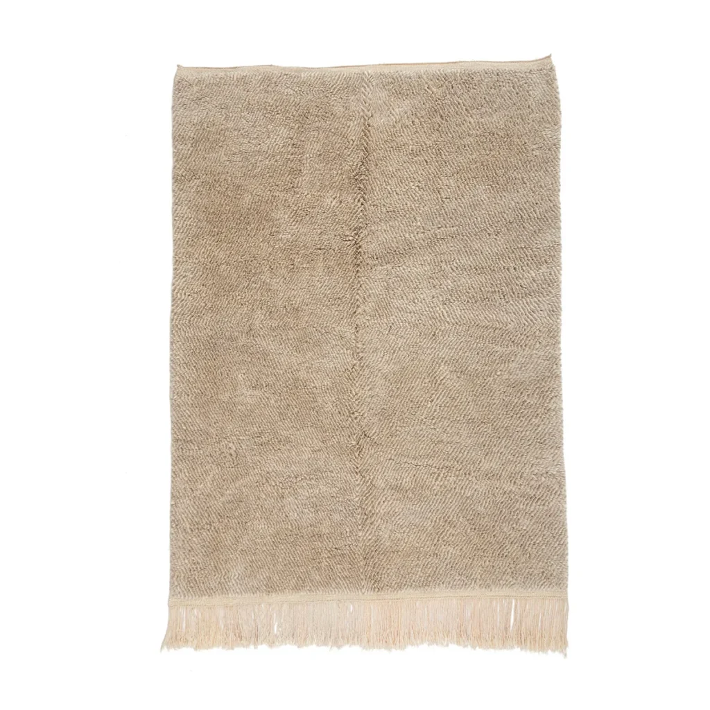 This luxury hand-knotted rug features a beige herringbone pattern and elegant fringed edges, adding a touch of sophistication to any space.