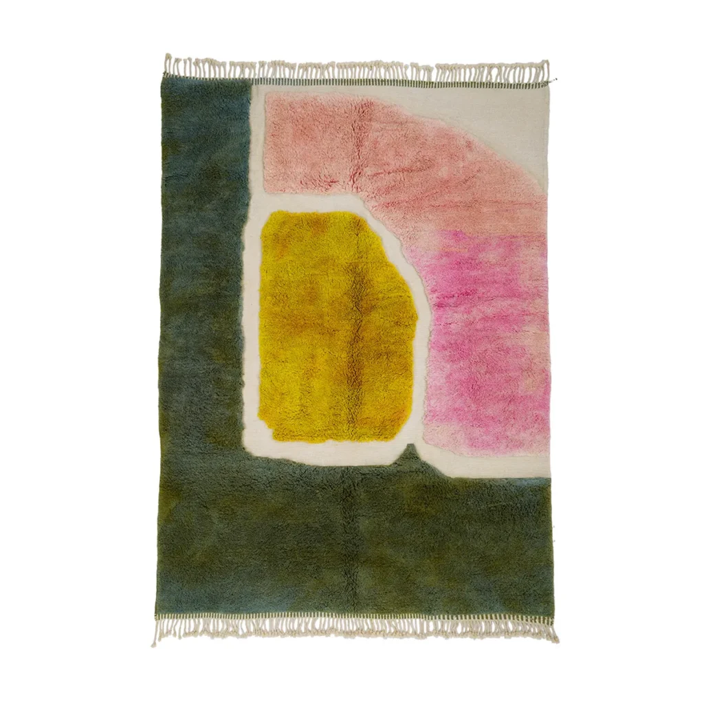 This luxurious rectangular rug features abstract shapes in pink, yellow, green, and white, with fringes adorning the shorter ends. Hand-knotted with precision, it adds a touch of elegance to any space.
