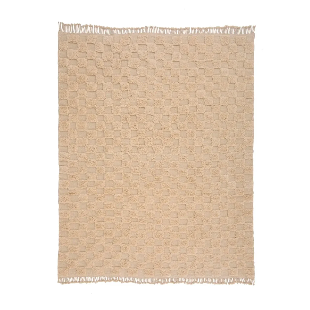 An artisanal beige woven rug with a checkered pattern and fringed edges on all sides is displayed flat against a white background. Inspired by authentic Moroccan rugs, this piece adds an elegant touch to any space.