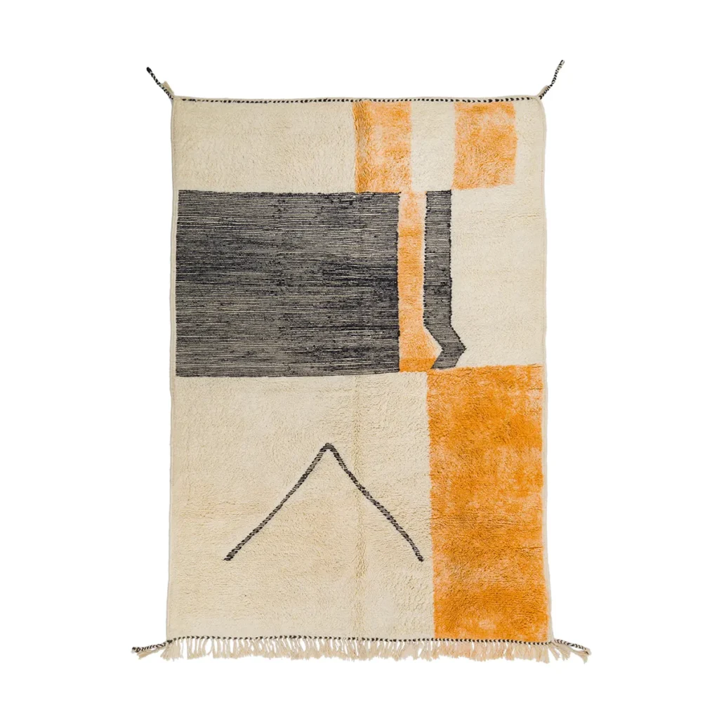 This rectangular rug showcases an abstract geometric design in black, orange, and beige, complemented by a stylish fringed edge at the bottom. Ideal for adding a modern touch to any living space.