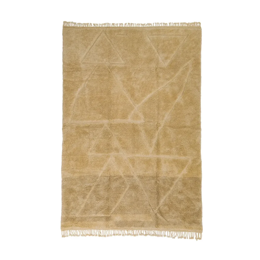 A beige area rug with a geometric pattern of triangles and abstract shapes, featuring fringe on the shorter ends. This artisanal rug is hand-knotted, ensuring exquisite craftsmanship and an authentic Moroccan feel.