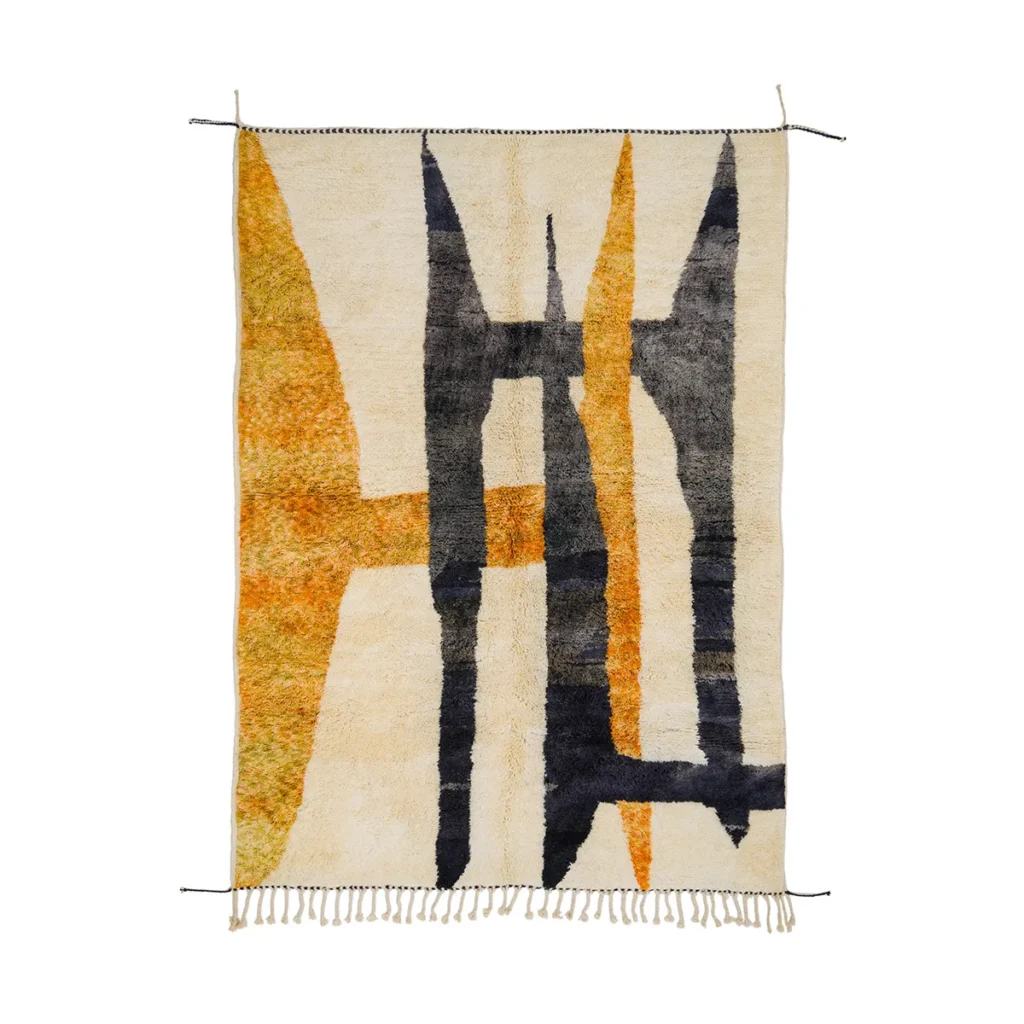 This hand-knotted, abstract rug showcases geometric patterns in black, orange, and beige. It features fringe on the shorter sides and a bold design with sharp shapes, exemplifying the beauty of authentic Moroccan rugs.