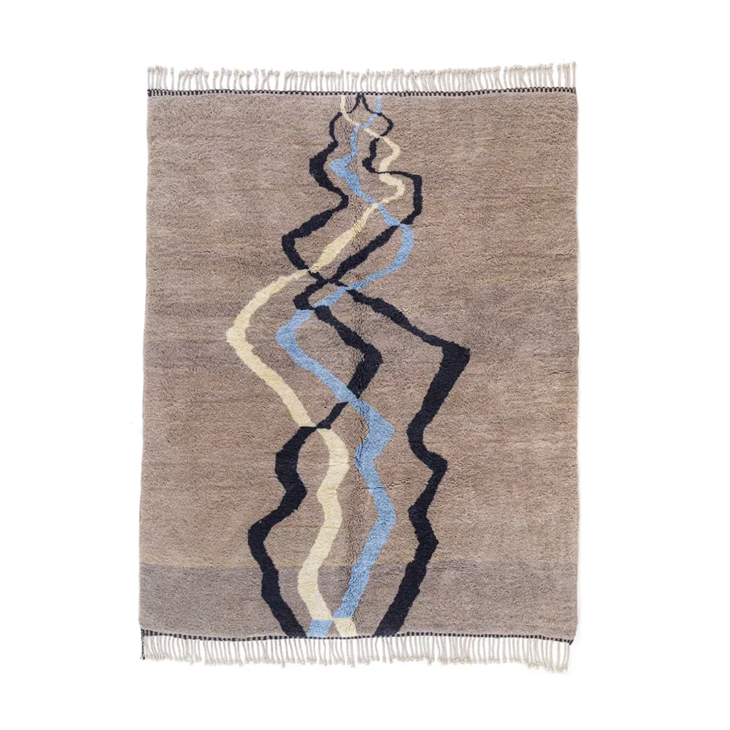 This luxury rug features abstract wavy lines in black, blue, and beige on a light brown background, complemented by elegant fringed edges. Perfect for adding a touch of sophistication to any room.