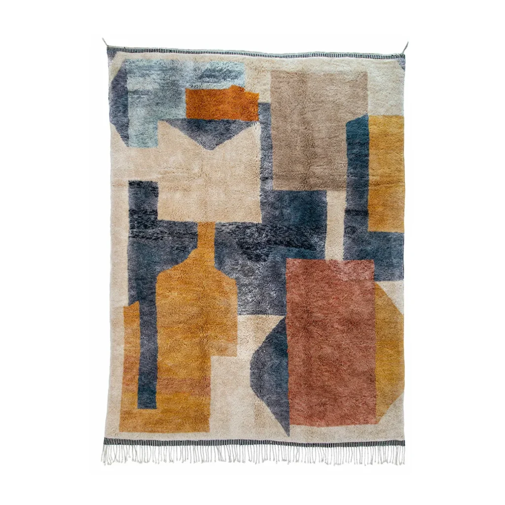 Artisanal rectangular rug with an abstract geometric design in blue, mustard, orange, and beige tones. Features fringe along the short ends, this hand-knotted piece offers a touch of elegance and authenticity to any space.