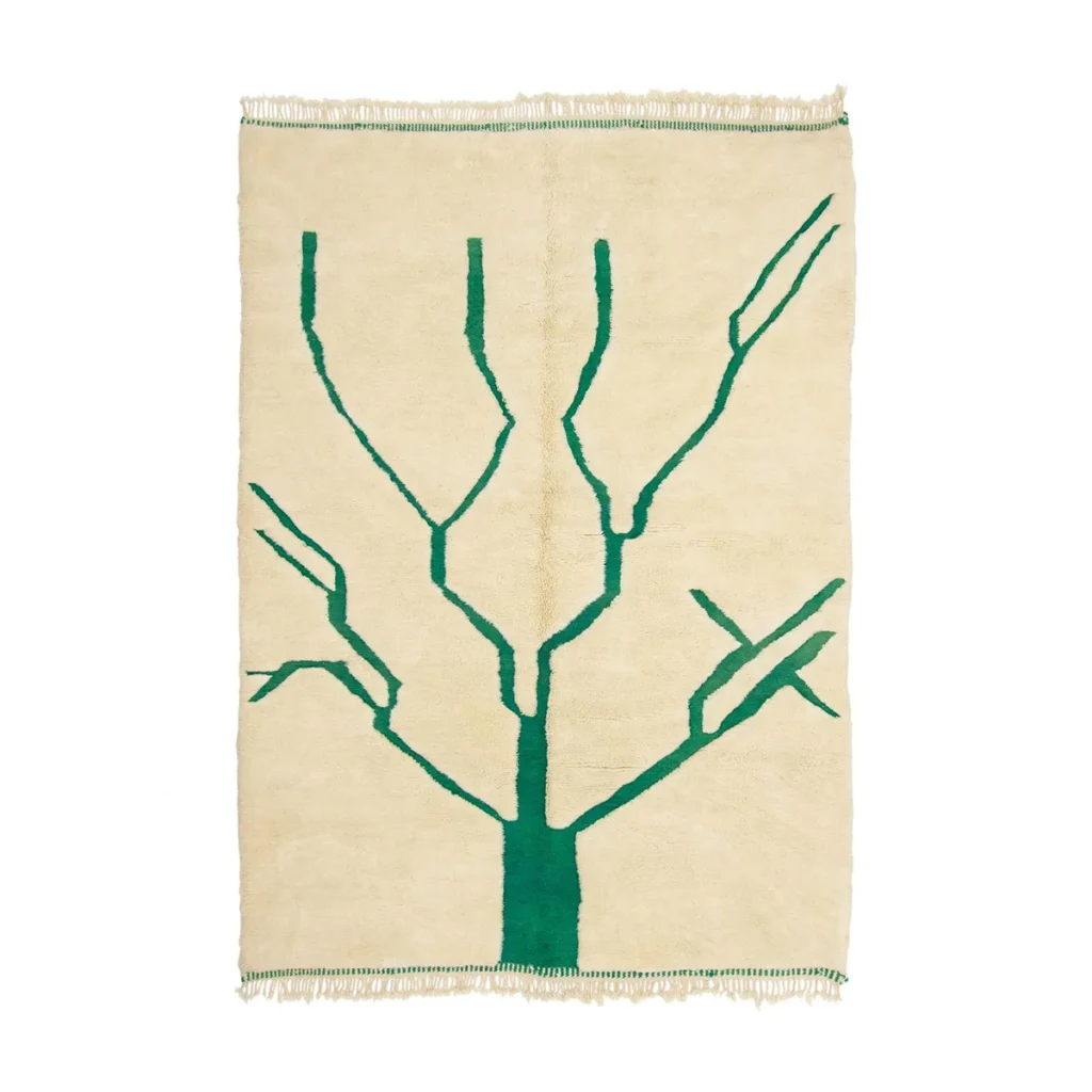 This hand-knotted, rectangular beige rug showcases a simple green tree branch design in the center and elegant fringes on the short sides, adding a touch of luxury to any space.