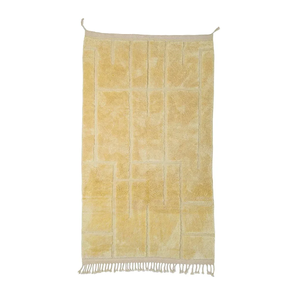 A beige textile with a geometric pattern and fringe tassels on the bottom edge hangs elegantly on two hooks, adding a touch of sophistication to your space.