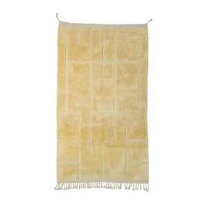 A beige textile with a geometric pattern and fringe tassels on the bottom edge hangs elegantly on two hooks, adding a touch of sophistication to your space.