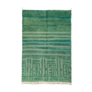 This luxurious green woven rug features horizontal stripes and fringe. The top showcases varying dark green shades, while the bottom reveals lighter stripes with a geometric pattern. Expertly hand-knotted, it adds an elegant touch to any room.
