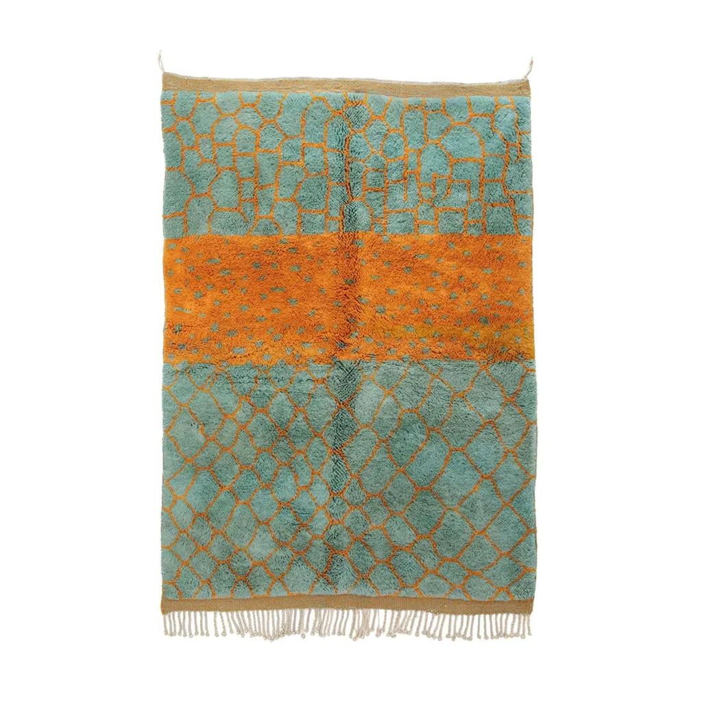 Authentic Moroccan rug with a vibrant blue and orange geometric pattern of interconnected shapes. The fringed edges enhance its artisanal charm, showcasing the intricate hand-knotted craftsmanship typical of genuine pieces.