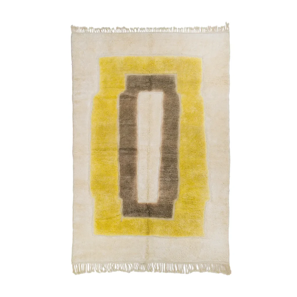 This luxurious rectangular rug showcases a central geometric design in brown and yellow on a cream background, complete with elegant fringed edges. Expertly hand-knotted, it brings sophistication and style to any room.