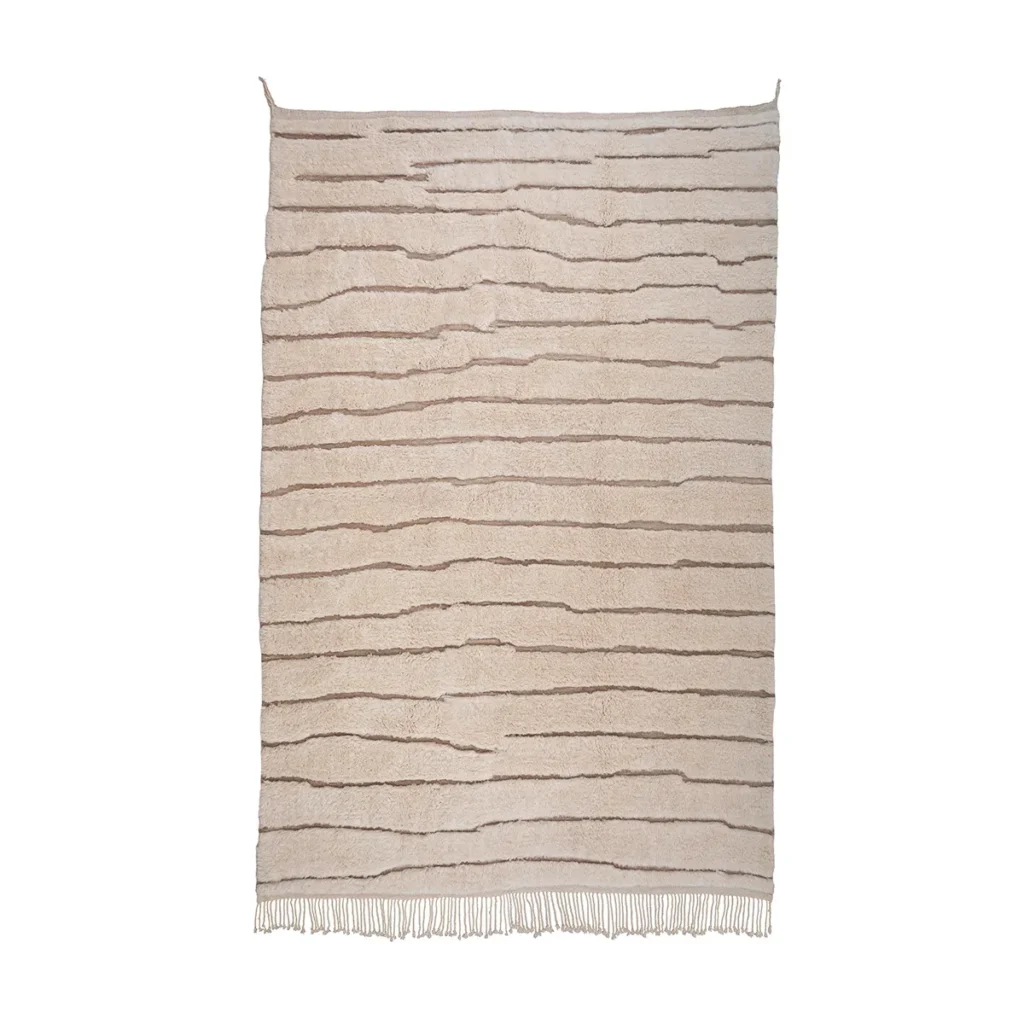 Discover the elegance of a beige luxury rug featuring irregular horizontal brown lines and adorned with fringe tassels. Perfect for adding a touch of handmade home decor charm to any space, this piece seamlessly blends style and comfort in your living area.