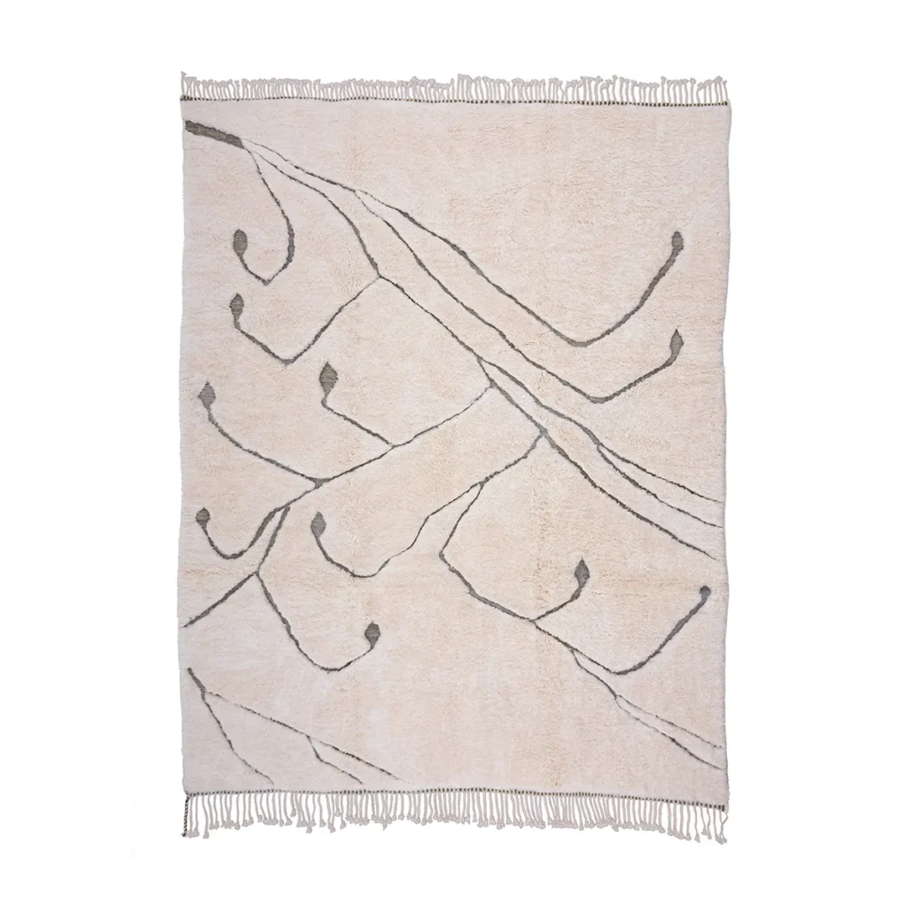 This luxury rug, hand-knotted in a creamy hue, features abstract gray branch-like lines and minimal fringe along the edges.
