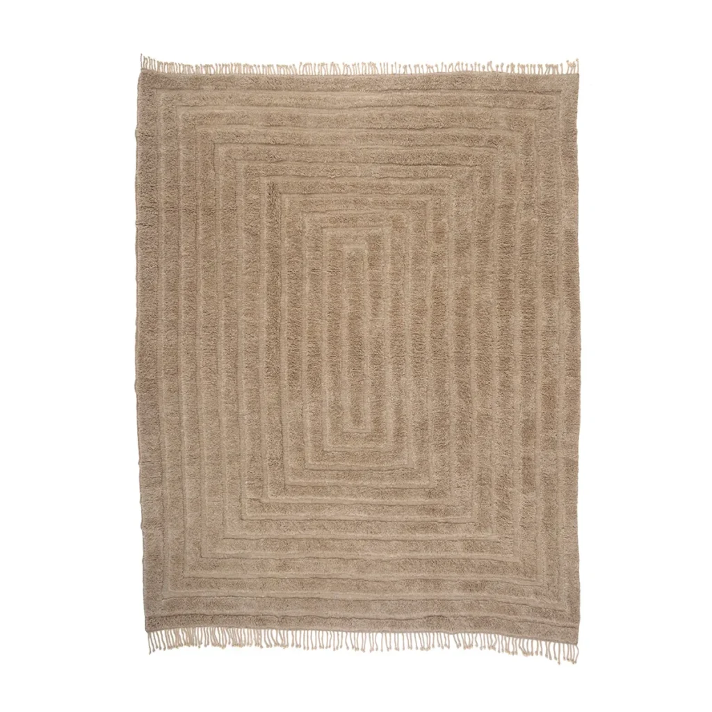This luxurious, hand-knotted rug features a beige, rectangular design with a textured, concentric square pattern. Fringes line the edges for an elegant finish.