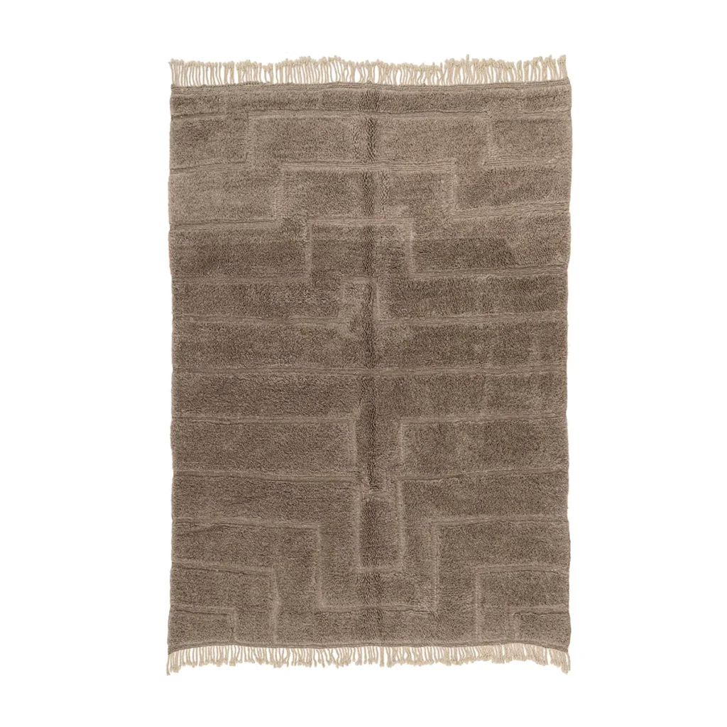 A beige rectangular rug features a textured geometric pattern, accented with fringe on two sides, adding a modern touch to any space.
