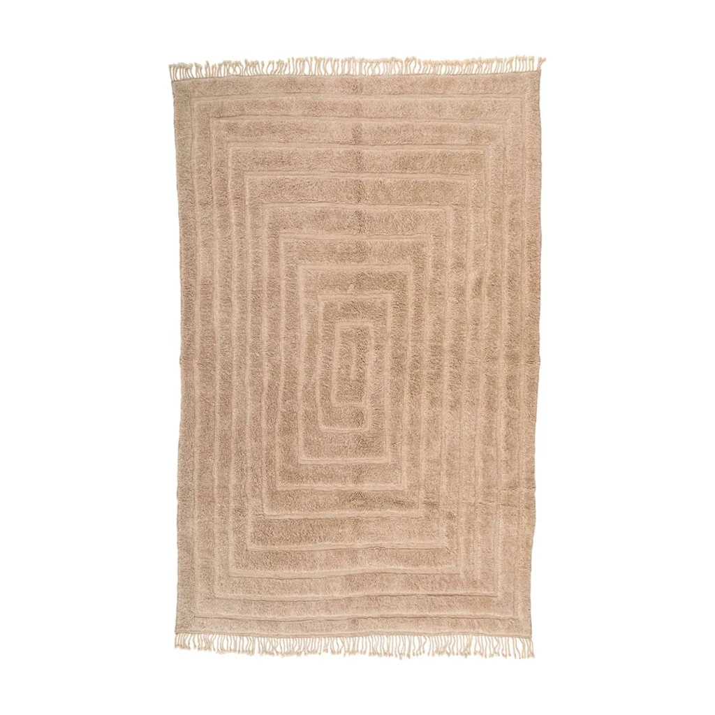 This luxurious rectangular beige rug features a hand-knotted geometric pattern of concentric rectangles, complemented by elegant fringe on its shorter edges.