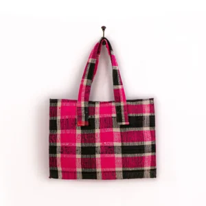 Pink and black plaid tote bag with two handles, hanging on a hook against a plain white background.