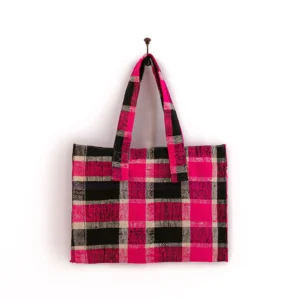 Pink and black checkered tote bag hanging on a hook against a white background.