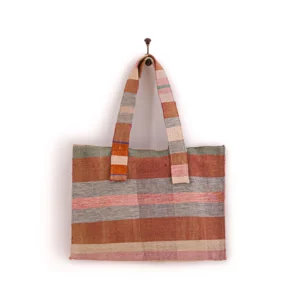 Woven tote bag with multicolored stripes, hanging on a single hook.