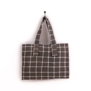 Gray checkered tote bag with two handles hanging on a wall hook.