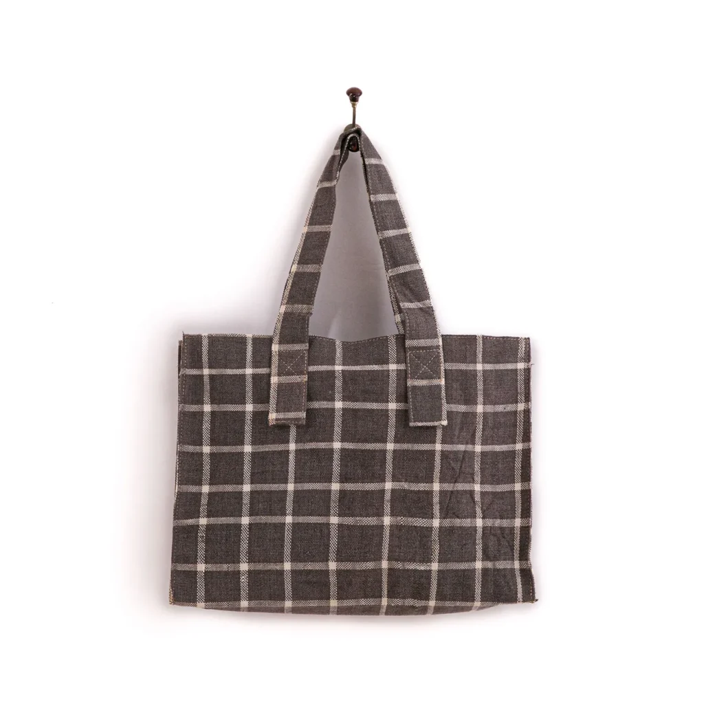 A gray plaid tote bag hangs on a single hook against a plain background.