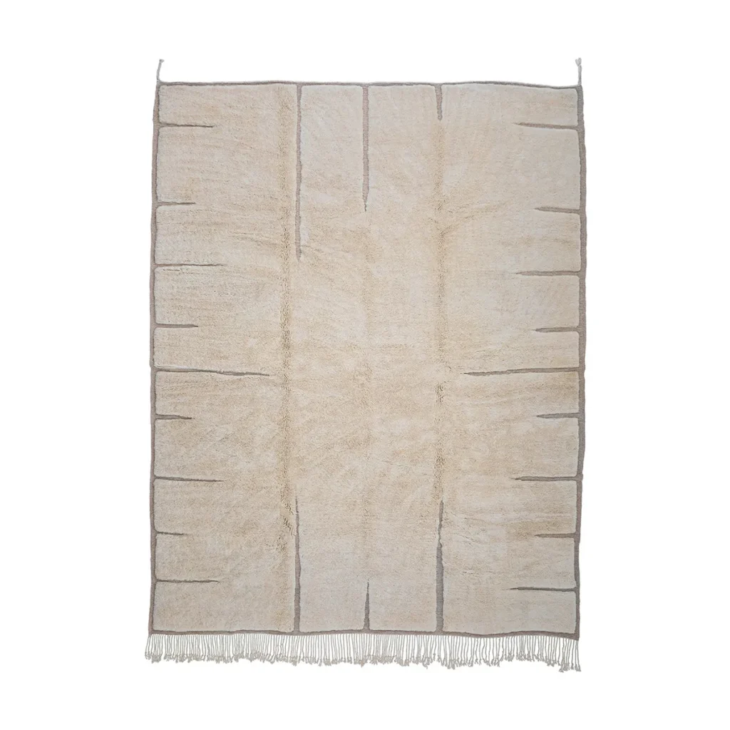 Luxurious hand-knotted beige area rug featuring subtle gray lines and a textured surface, with fringe on the shorter edges, set against a pristine white background.